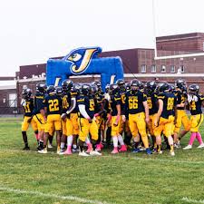 Seaford football team running onto the field together.