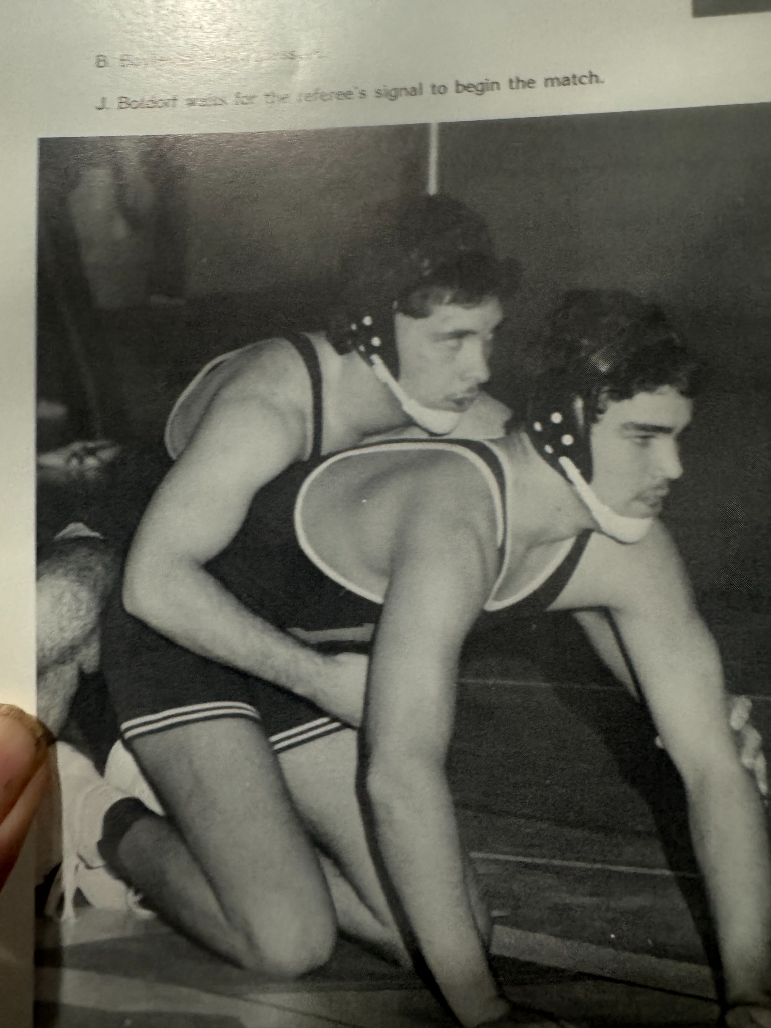 Two wrestlers prepare for the start of a match.